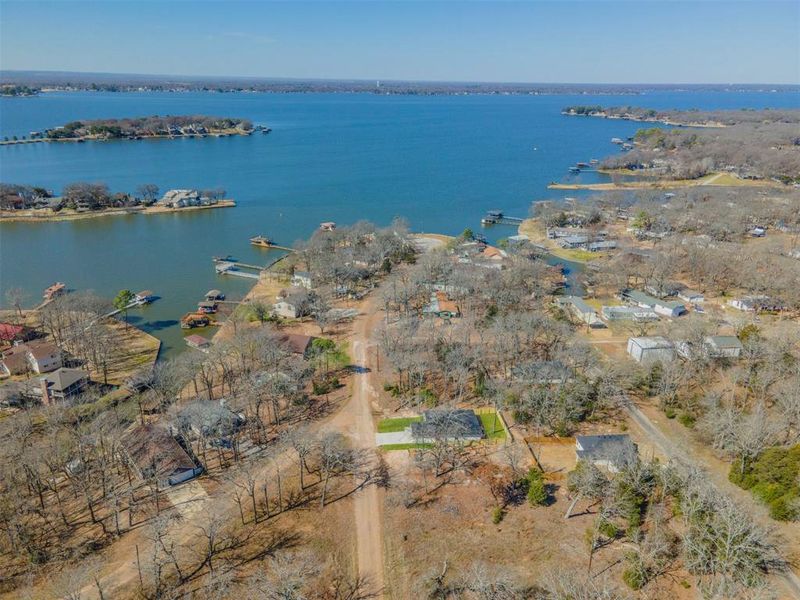 Birds eye view of property with a water view