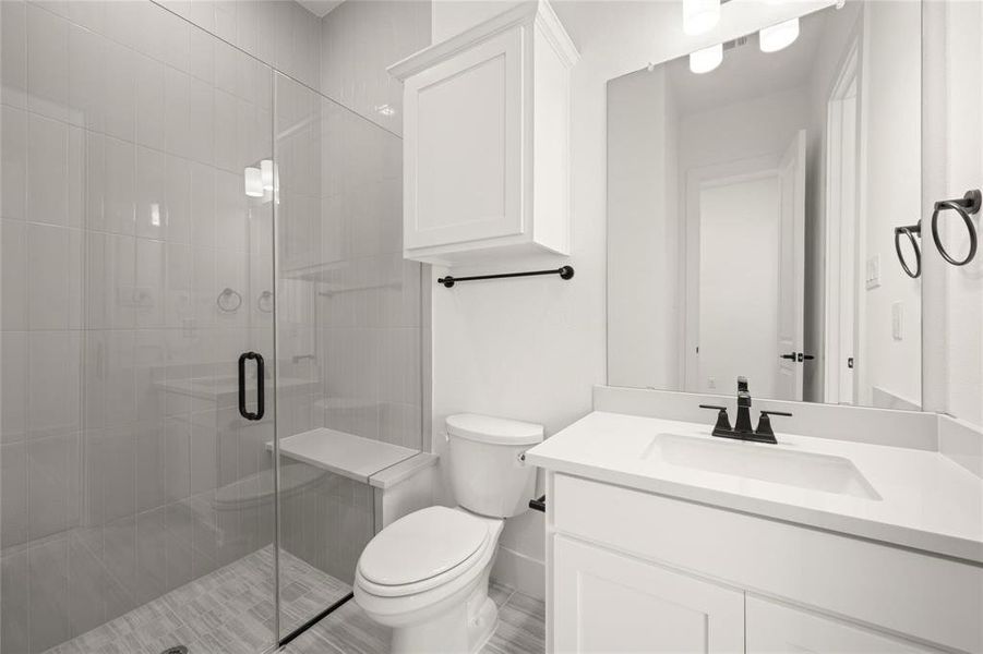 Bathroom featuring vanity and a shower stall
