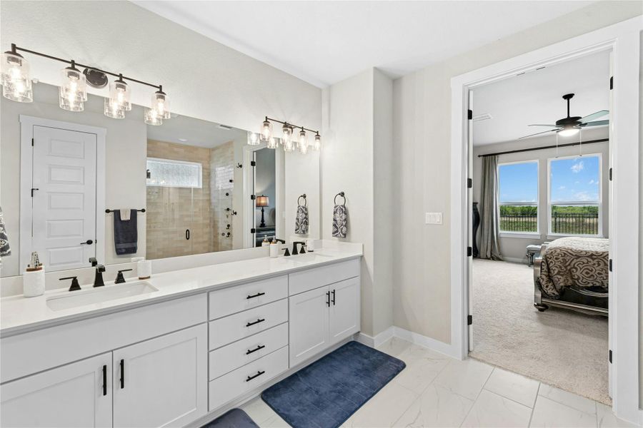 Full bath featuring double vanity, ensuite bath, with upgraded shower