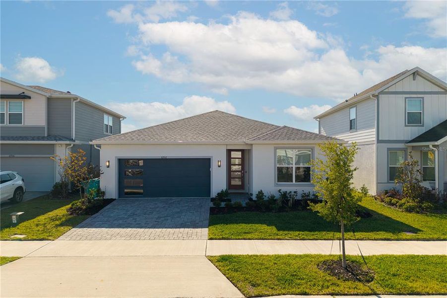 Front exterior of a new home in EverBe, Orlando, FL, highlighting curb appeal (Image 29).