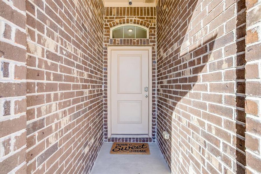 Doorway to property with brick siding