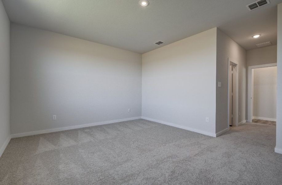 A room with a carpet and a door.