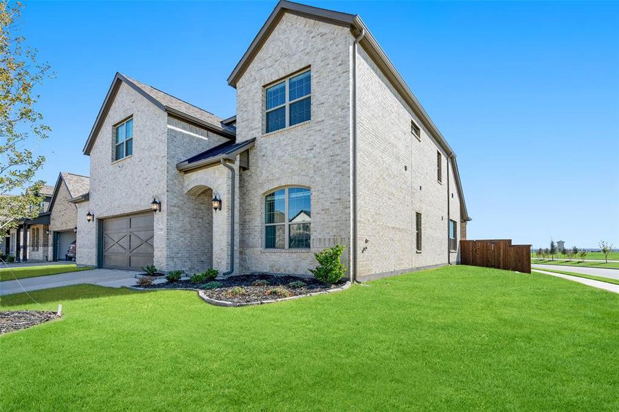 View of front of home featuring a front yard and a garage