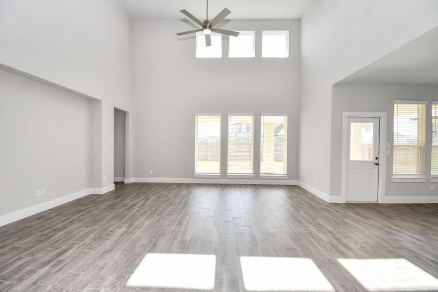Take another glimpse into the heart of the home with this additional view of the family room—a sprawling space ready to accommodate all your gatherings. Sample photo of completed home with similar floor plan. Actual colors and selections may vary.