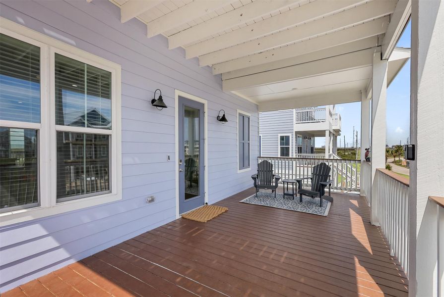 The first-floor balcony entry sets the tone for relaxation and comfort, offering shaded seating areas perfect for enjoying the outdoors in any season.