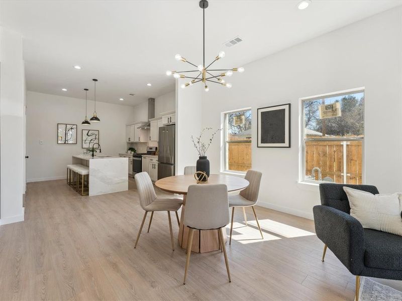 Dining space featuring baseboards, light wood-type flooring, and recessed lighting