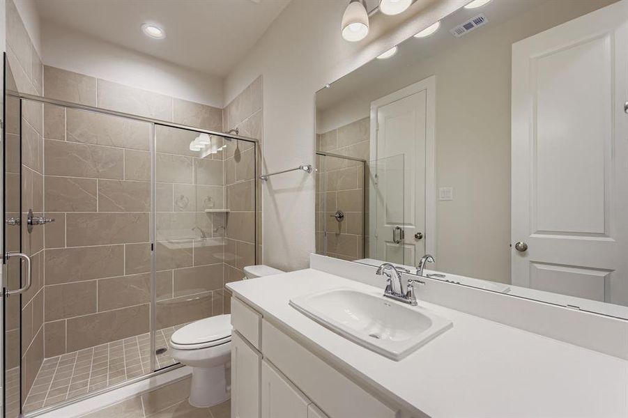 Full bathroom with vanity, a stall shower, light tile patterned flooring, and recessed lighting