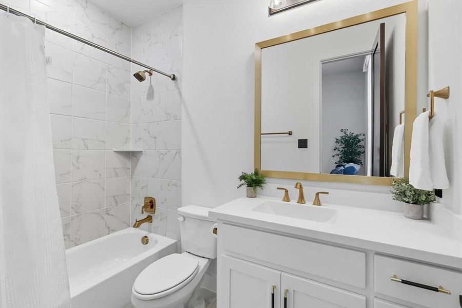 1st floor ensuite bathroom featuring shower / bathtub combination with curtain and vanity 1st floor ensuite bathroom featuring shower / bathtub combination with curtain and vanity