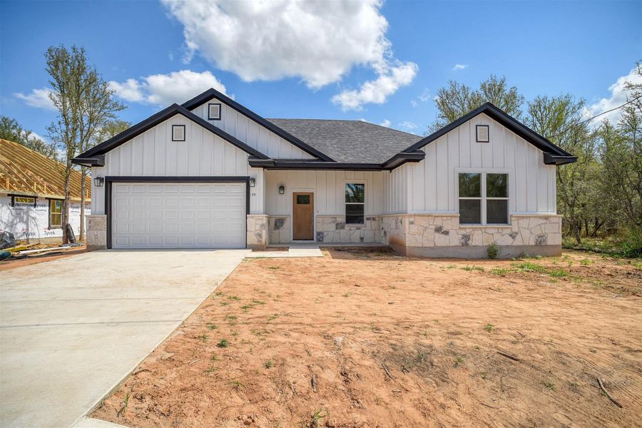 Front exterior of a new home in , Bastrop, TX, highlighting curb appeal (Image 18).