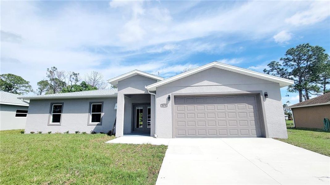 Front exterior of a new home in , North Port, FL, highlighting curb appeal (Image 1). Front exterior of a new home in , North Port, FL, highlighting curb appeal (Image 1).
