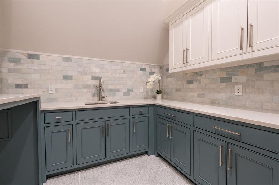 Utility room with custom cabinets and sink