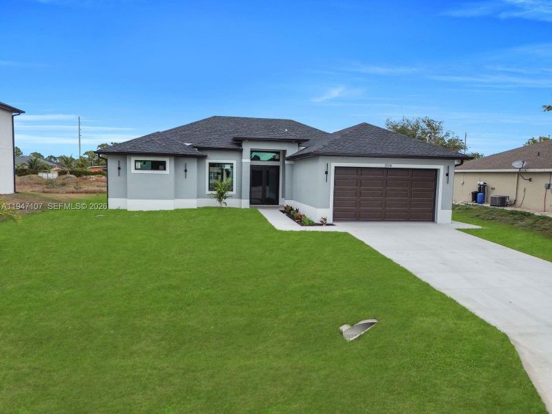 Front exterior of a new home in , Lehigh Acres, FL, highlighting curb appeal (Image 21).
