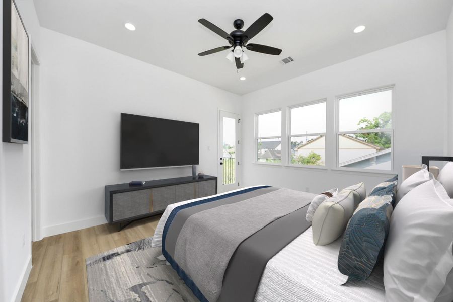 Spacious primary bedroom w/ private balcony.