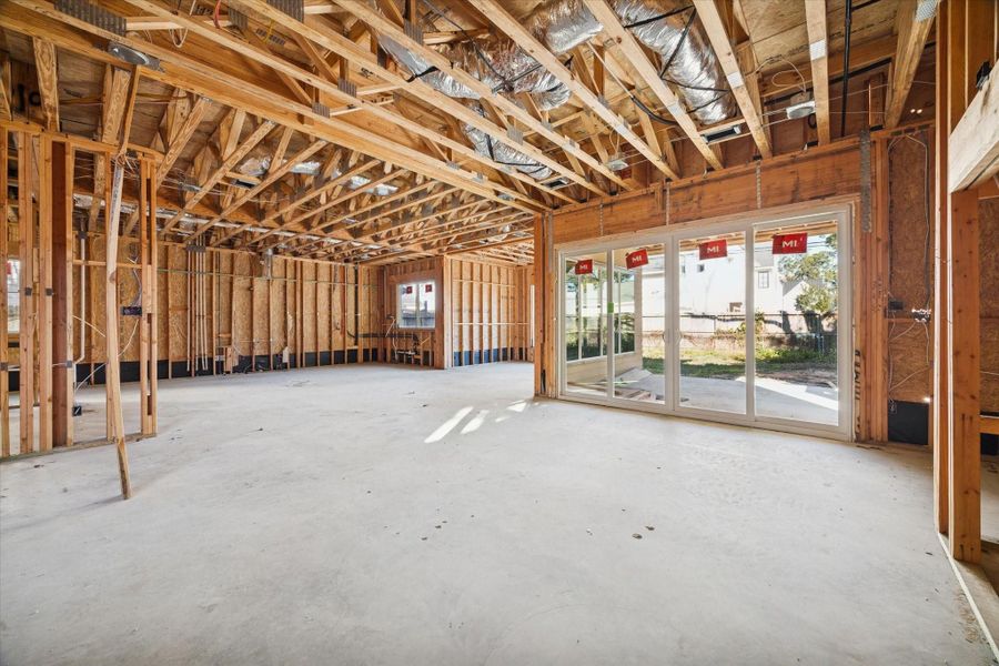 LIVING ROOM - Living room overlooking the sliding doors leading to your backyard oasis. Main living areas offer an open concept floor plan. -- **Current construction as of 12/31/2025**
