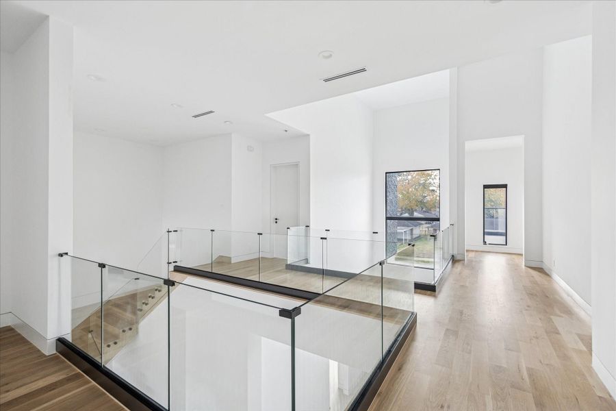 The light and bright hallways are complete with tall ceilings and glass balcony.