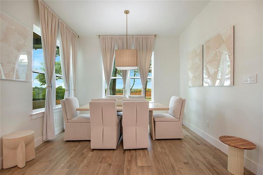Dining space with light wood finished floors Dining space with light wood finished floors