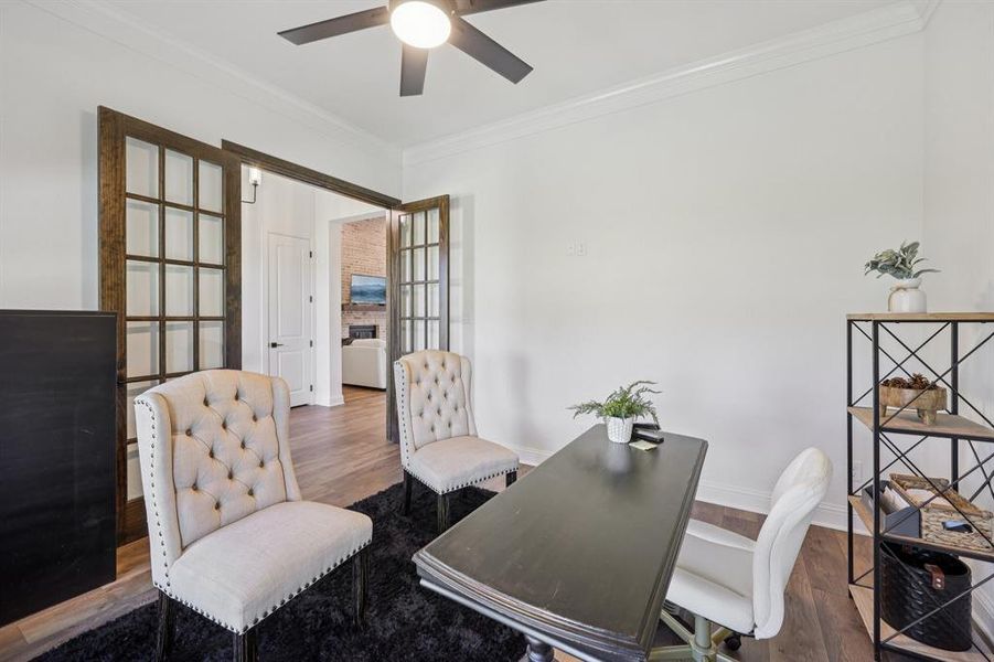 Office area featuring ornamental molding, wood finished floors, french doors, and a ceiling fan Office area featuring ornamental molding, wood finished floors, french doors, and a ceiling fan