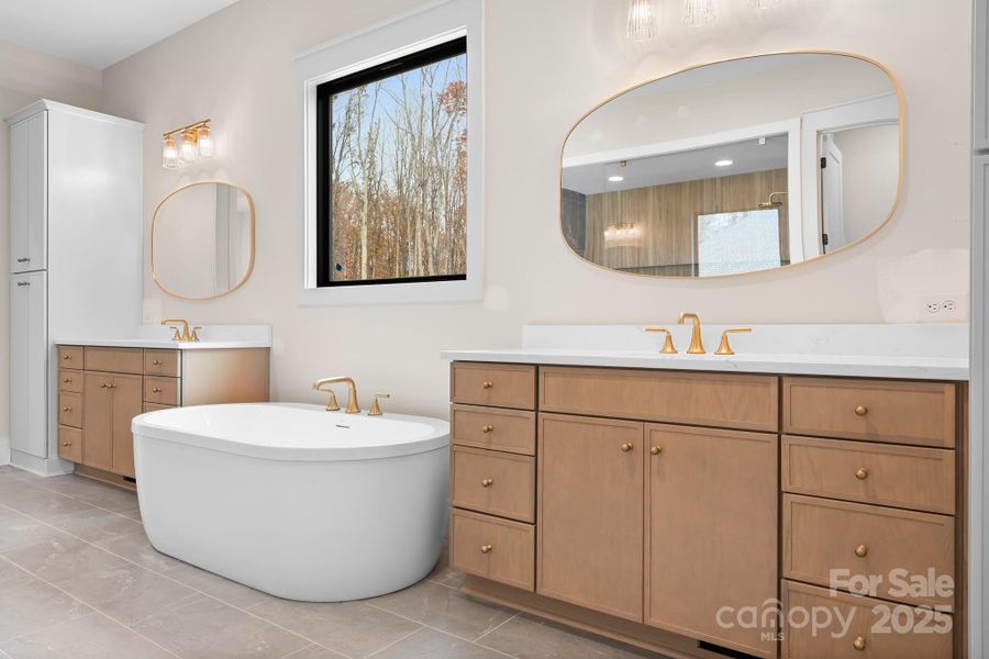 A spa-inspired primary bath features separate vanities, a soaking tub and huge walk-in shower. A spacious linen closet plus built in cabinetry, lots of drawer space, abundant natural light and beautiful designer finishes complete this sanctuary.