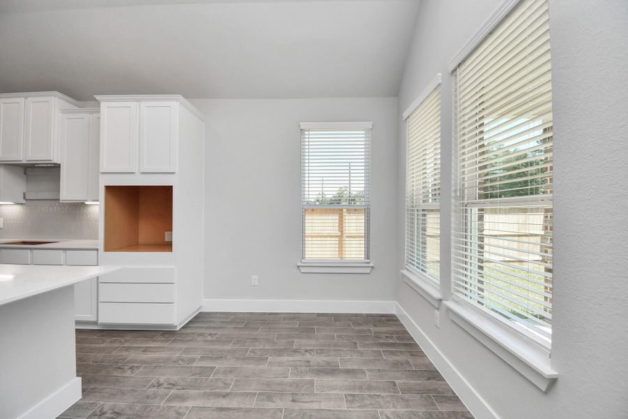 Enjoy breakfast with ease in the connected and cozy breakfast area, seamlessly integrated with the kitchen for utmost convenience. Step through the back door for a breath of fresh air onto the covered patio, extending your living space to the outdoors. Sample photo of completed home with similar floor plan. Actual colors and selections may vary. Enjoy breakfast with ease in the connected and cozy breakfast area, seamlessly integrated with the kitchen for utmost convenience. Step through the back door for a breath of fresh air onto the covered patio, extending your living space to the outdoors. Sample photo of completed home with similar floor plan. Actual colors and selections may vary.