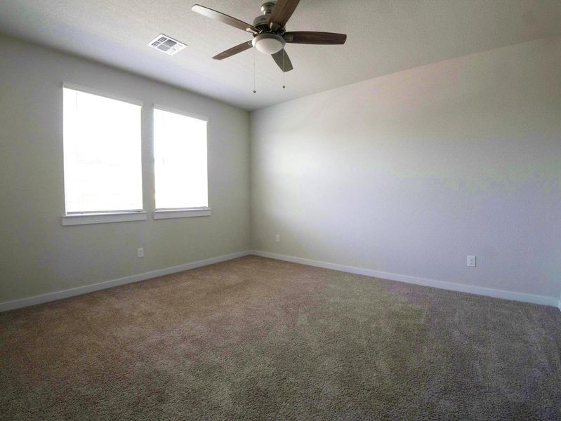 Empty room featuring carpet floors and ceiling fan Empty room featuring carpet floors and ceiling fan