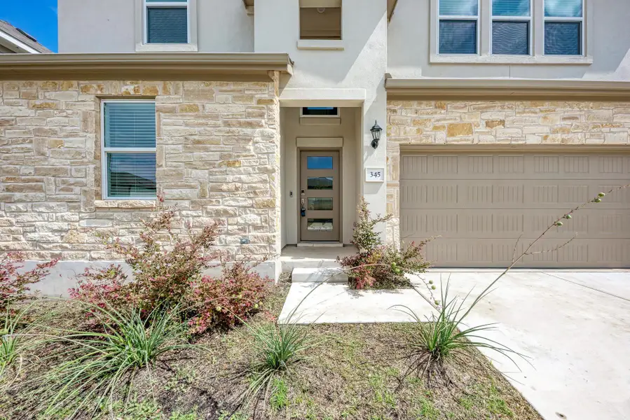 A striking facade with varied textures, blending stone and stucco.