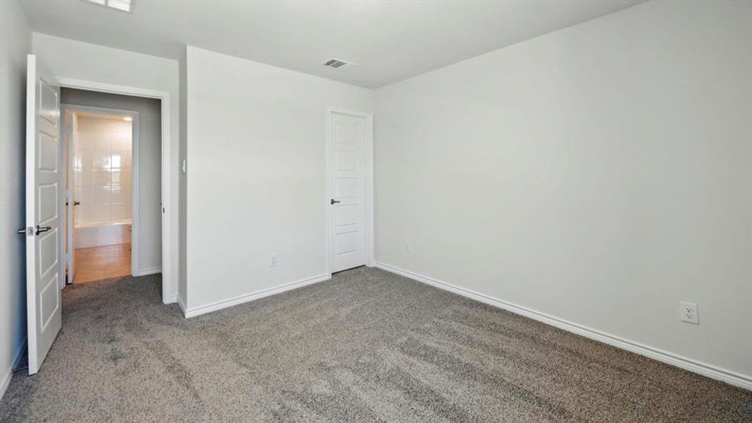 Unfurnished bedroom with carpet and baseboards