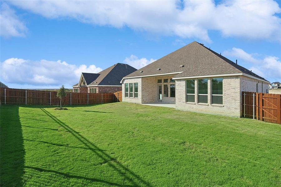 Rear view of property featuring a yard