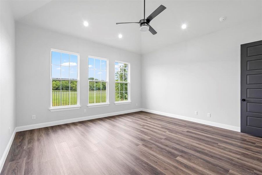 Spare room with ceiling fan and dark wood-type flooring