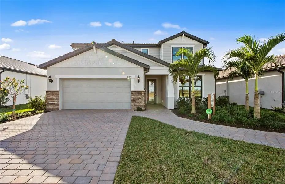 Front exterior of a new home in Grandura, Sarasota, FL, highlighting curb appeal (Image 1). Front exterior of a new home in Grandura, Sarasota, FL, highlighting curb appeal (Image 1).