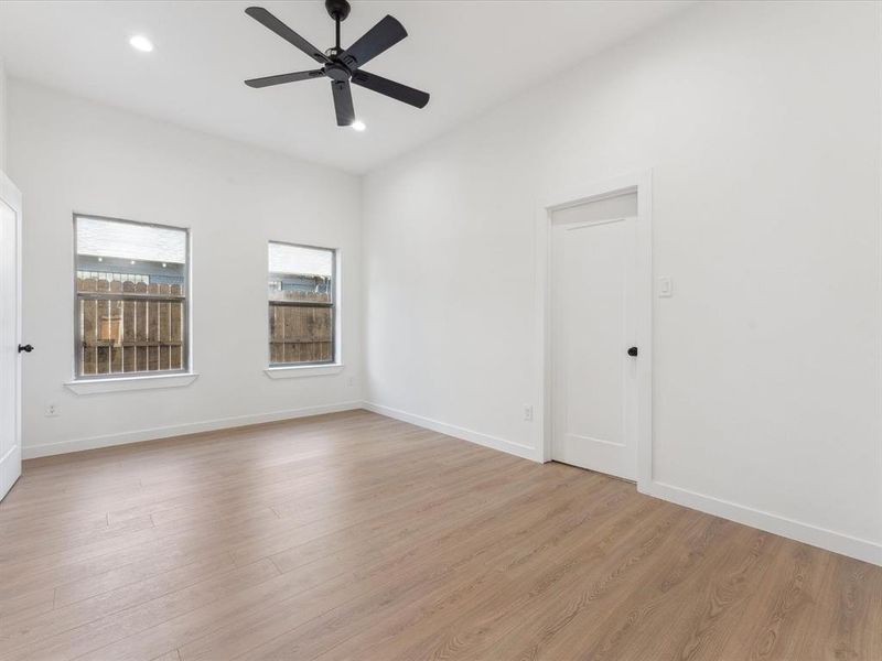 Spare room with baseboards, light wood finished floors, a ceiling fan, and recessed lighting