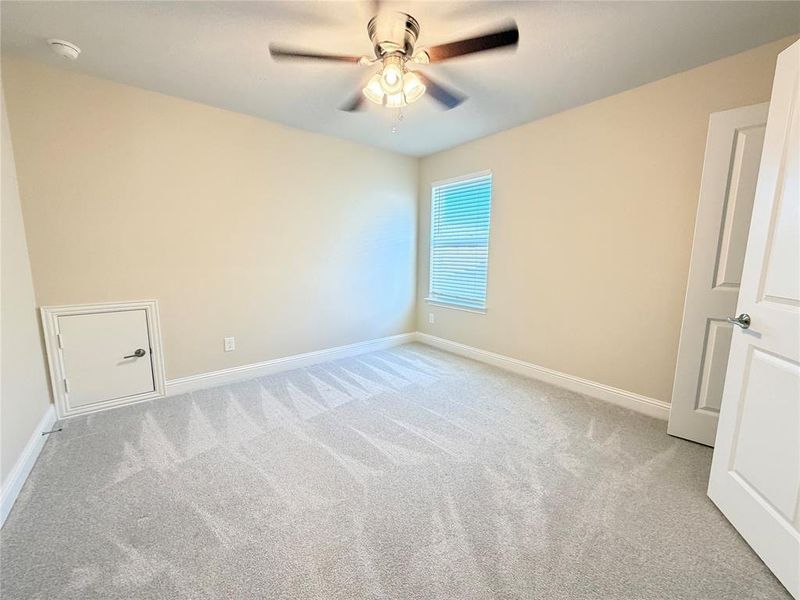 Unfurnished room with light colored carpet and a ceiling fan Unfurnished room with light colored carpet and a ceiling fan