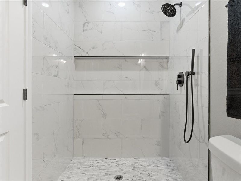 Full bathroom with a marble finish shower Full bathroom with a marble finish shower