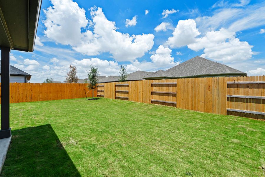 A well-maintained lawn provides a spacious and private outdoor living area.