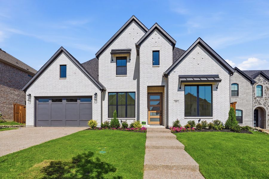 Front exterior of a new home in Inspiration - Paradise Village, Lucas, TX, highlighting curb appeal (Image 1). Front exterior of a new home in Inspiration - Paradise Village, Lucas, TX, highlighting curb appeal (Image 1).