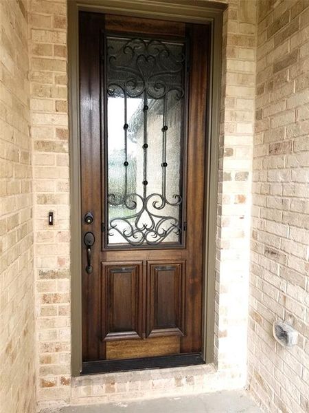 Impressive first impression with 8 ft iron & glass front door.