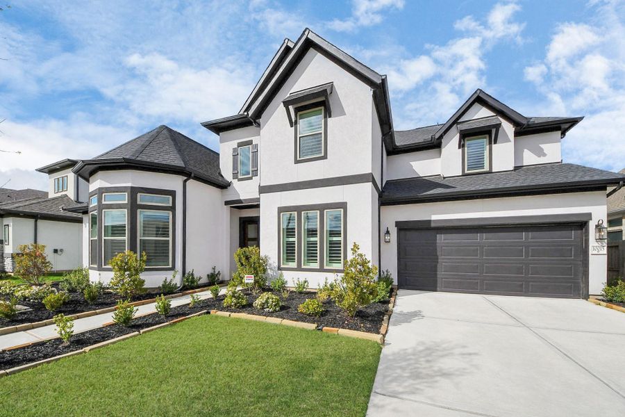 Front exterior of a new home in Sienna 70', Missouri City, TX, highlighting curb appeal (Image 2). Front exterior of a new home in Sienna 70', Missouri City, TX, highlighting curb appeal (Image 2).