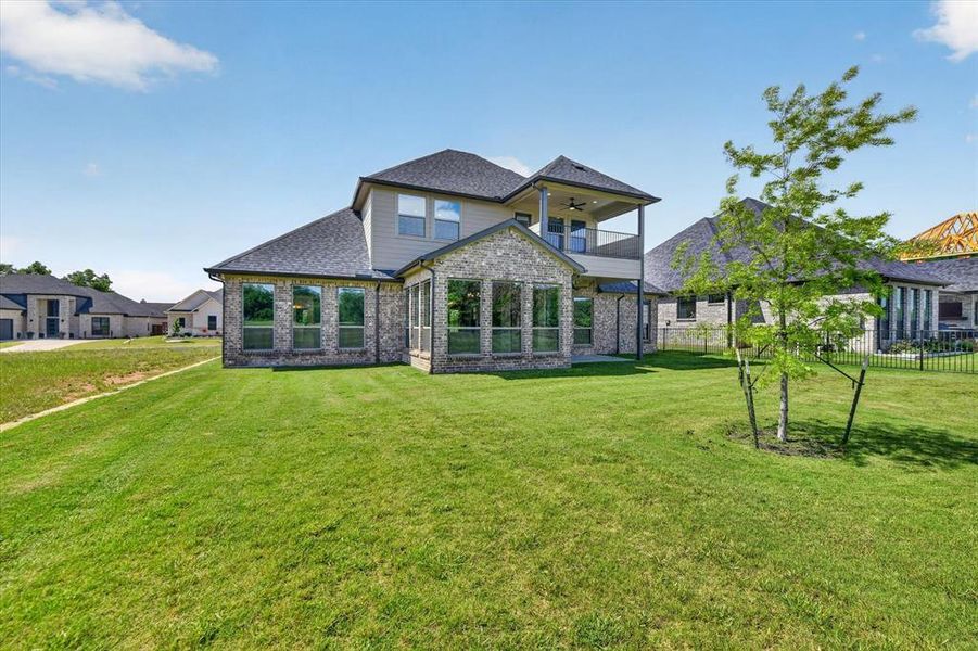 Rear exterior showcasing a two-story design with a covered second-story balcony