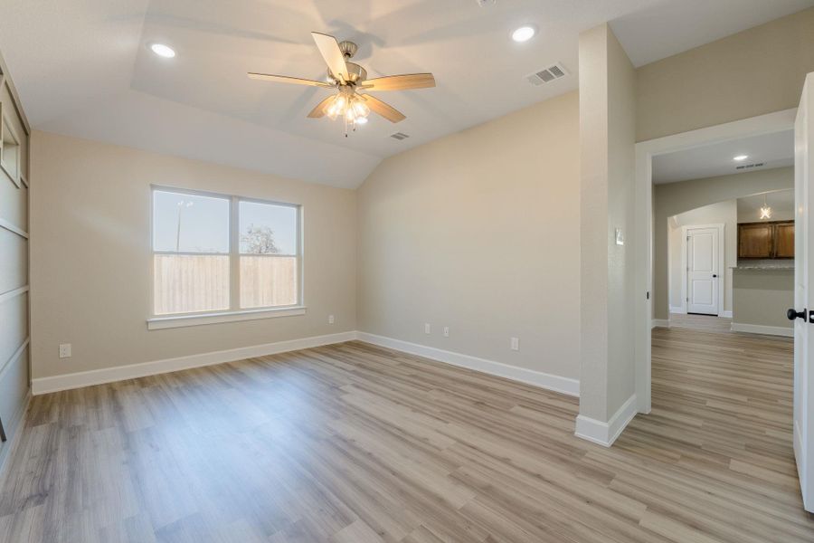 Empty room with recessed lighting, a ceiling fan, light wood-type flooring, and vaulted ceiling