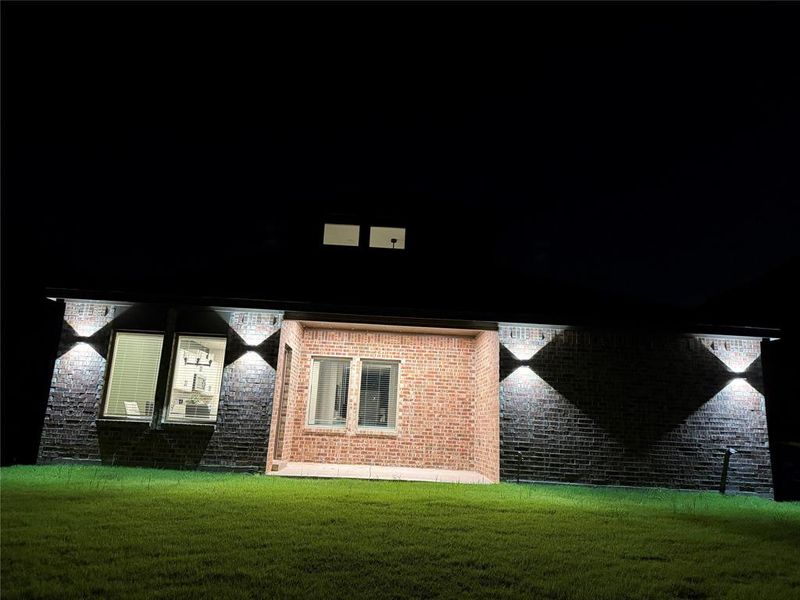 Brick exterior with modern up/down lighting fixtures