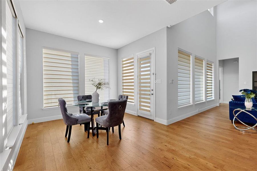 Dining space with plenty of natural light, light wood-style floors, and recessed lighting