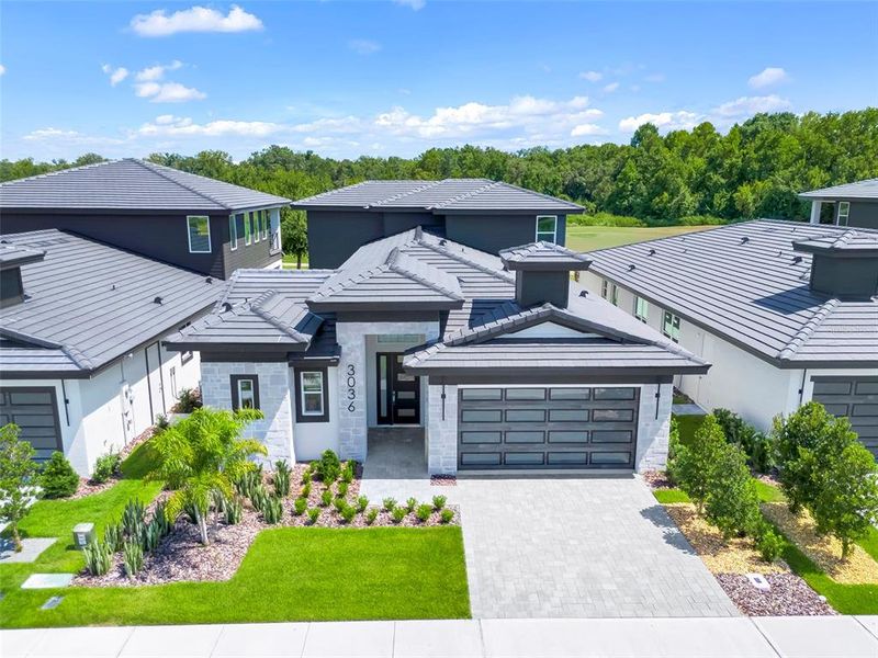 Front exterior of a new home in Hampton Green at Providence, Davenport, FL, highlighting curb appeal (Image 31).