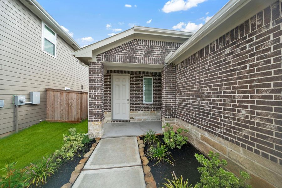 Front exterior of a new home in Colony at Pinehurst 40s, Pinehurst, TX, highlighting curb appeal (Image 16).
