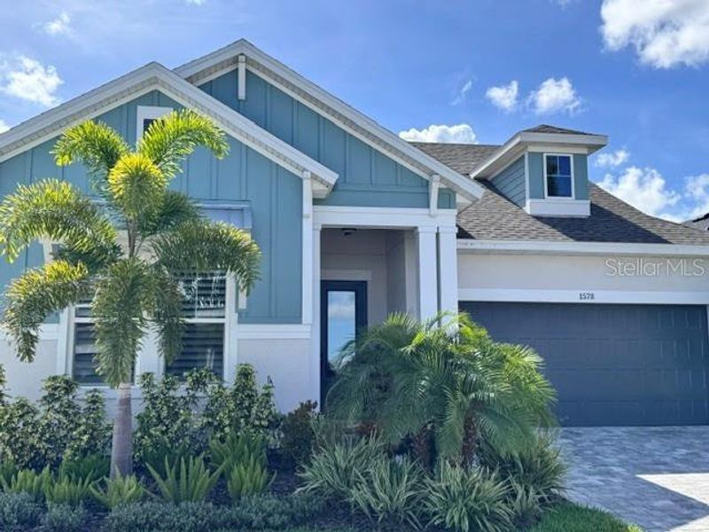 Front exterior of a new home in Emerald Landing at Waterside at Lakewood Ranch – Lake Series, Sarasota, FL, highlighting curb appeal (Image 3). Front exterior of a new home in Emerald Landing at Waterside at Lakewood Ranch – Lake Series, Sarasota, FL, highlighting curb appeal (Image 3).