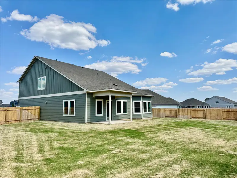 Back of house featuring a patio area, a fenced backyard, and a shingled roof Back of house featuring a patio area, a fenced backyard, and a shingled roof