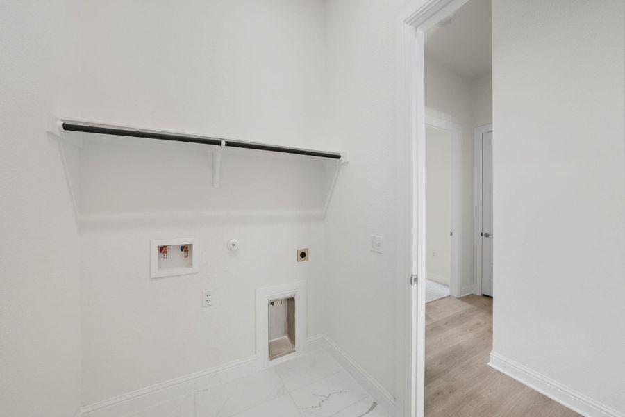 Laundry room with gas dryer hookup, electric dryer hookup, and washer hookup Laundry room with gas dryer hookup, electric dryer hookup, and washer hookup