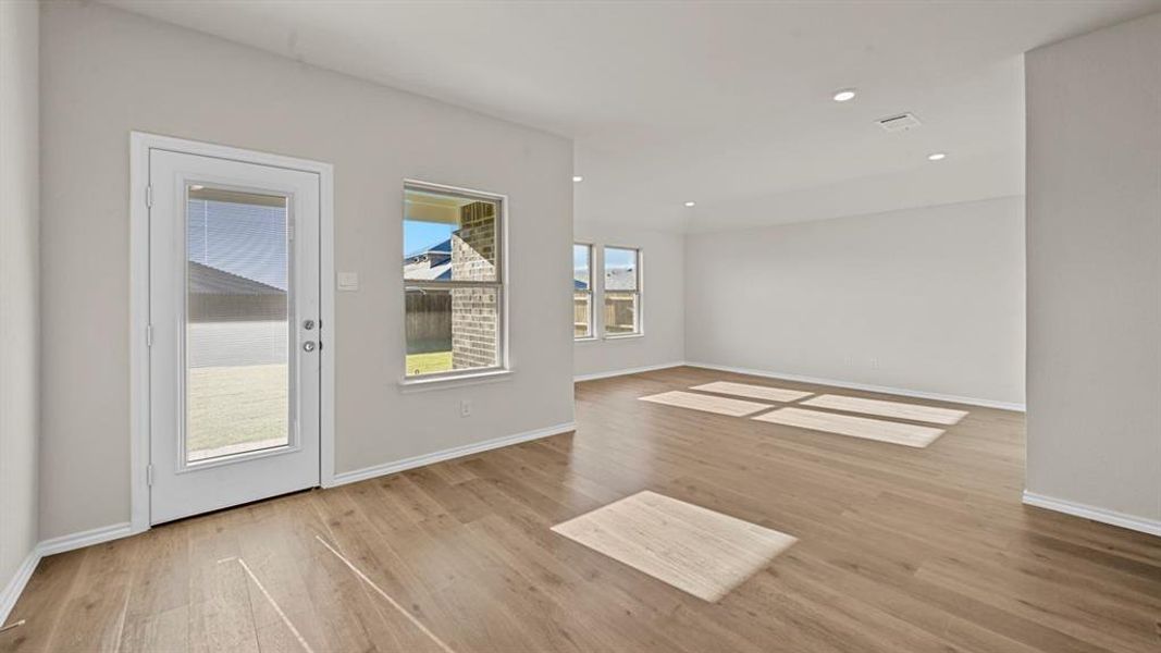 Spare room with light wood-style floors and recessed lighting