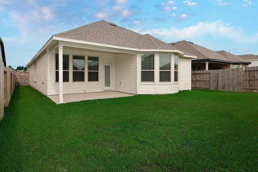 Front exterior of a new home in Mavera, Conroe, TX, highlighting curb appeal (Image 1).