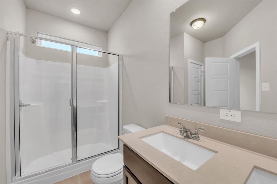 Full bathroom with a stall shower and vanity