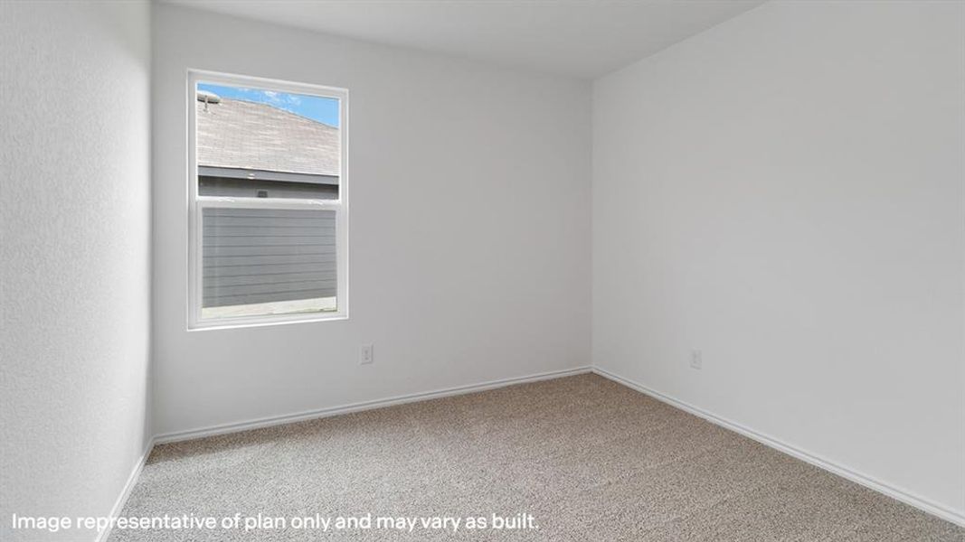 Carpeted spare room with baseboards