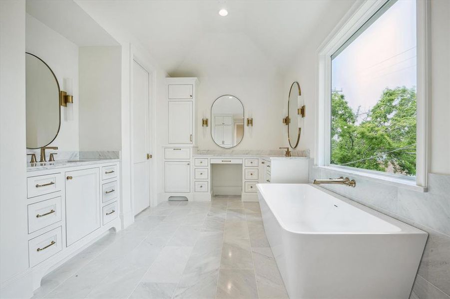 Primary spa-like bath features large soaking tub, & dual vanities